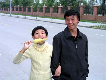 Chinese girl eats corn.JPG